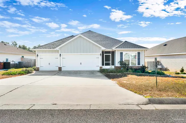 a view of a white house with a yard