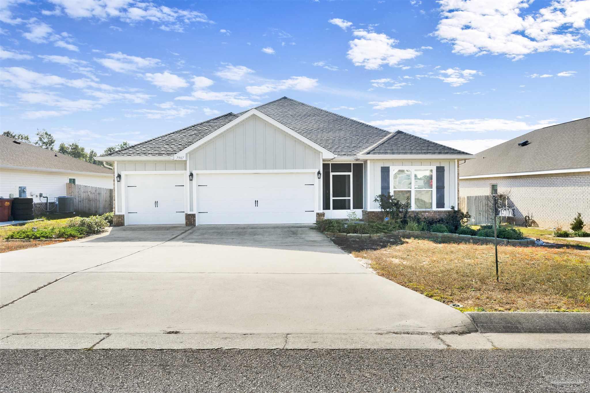 a view of a white house with a yard