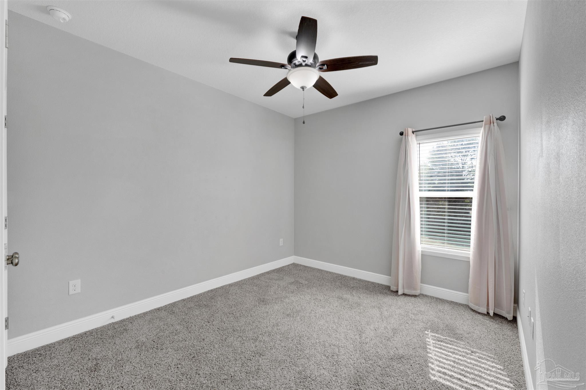 7907 Majestic Cypress Drive Milton, FL 32583 - Photo 19 of 36 a view of an empty room with a window