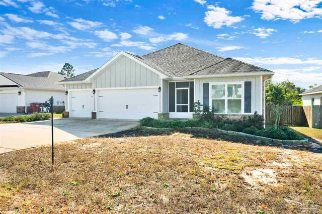 a view of a house next to a yard