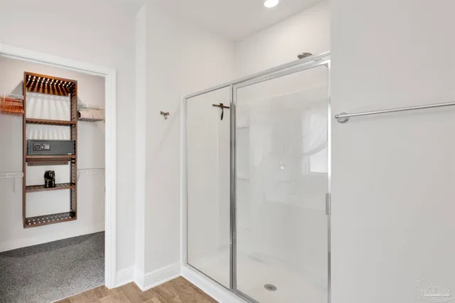a bathroom with a shower and a glass door