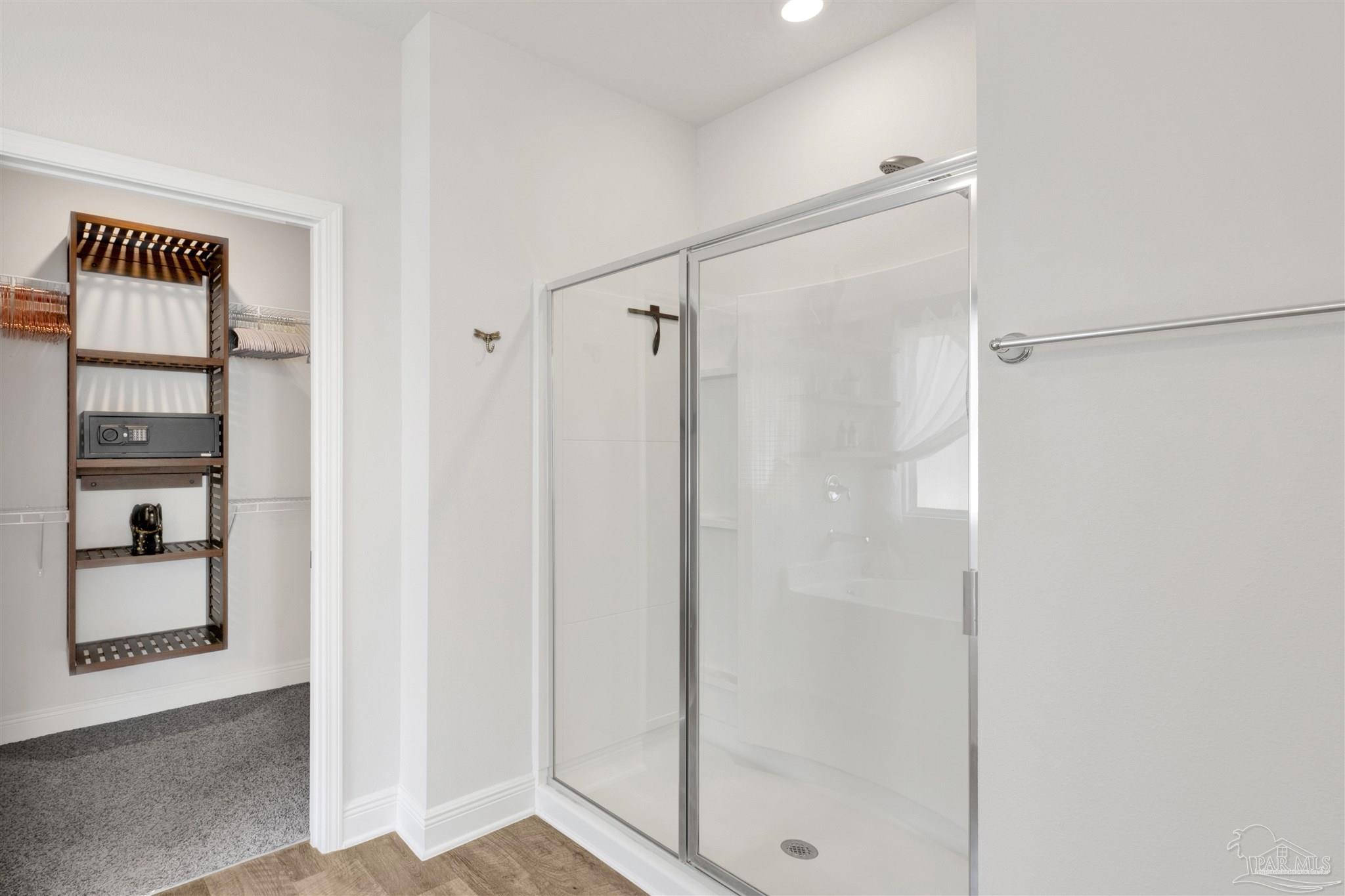 7907 Majestic Cypress Drive Milton, FL 32583 - Photo 23 of 36 a bathroom with a shower and a glass door