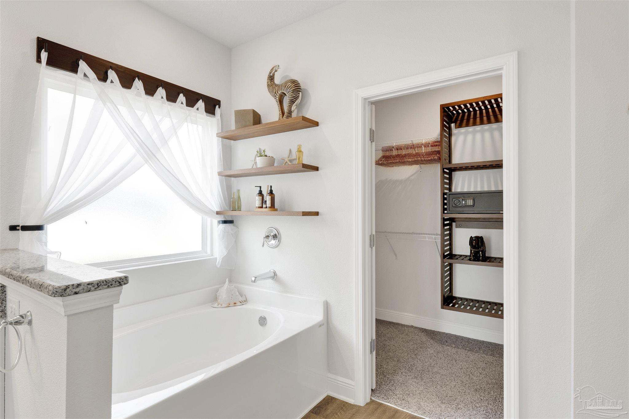 7907 Majestic Cypress Drive Milton, FL 32583 - Photo 24 of 36 a bathroom with a bathtub and a shower