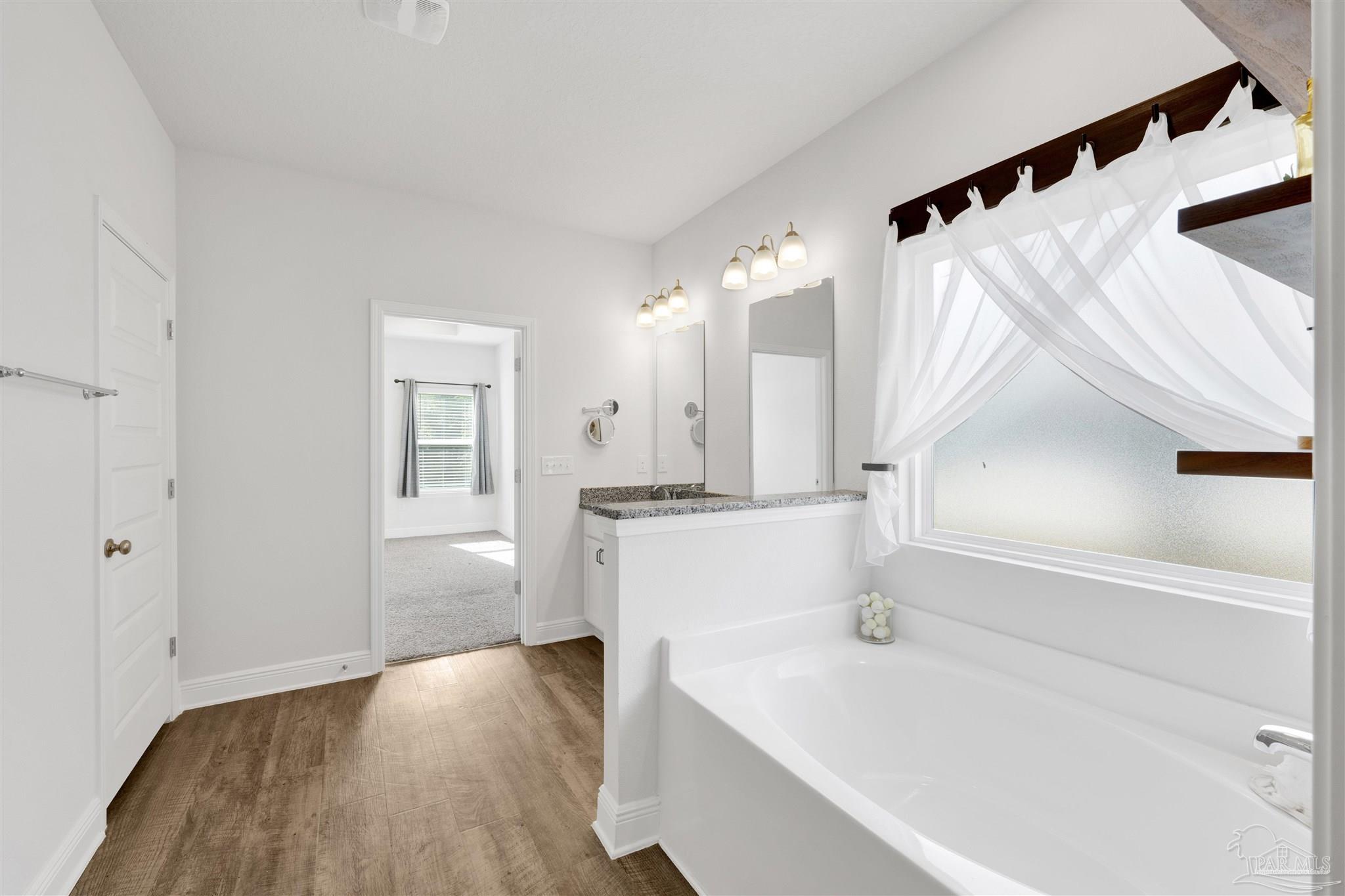 7907 Majestic Cypress Drive Milton, FL 32583 - Photo 25 of 36 a large white kitchen with sink a refrigerator and white cabinets