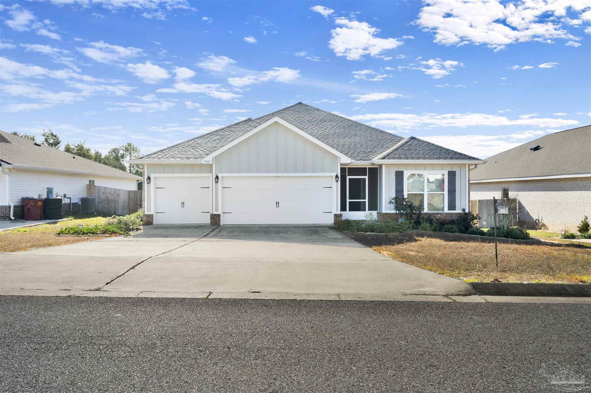 7907 Majestic Cypress Drive Milton, FL 32583 - Photo 3 of 36 a view of garage yard and tree