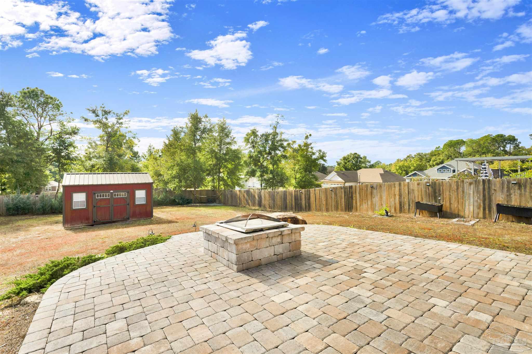 7907 Majestic Cypress Drive Milton, FL 32583 - Photo 31 of 36 a swimming pool with yard and trees in the background