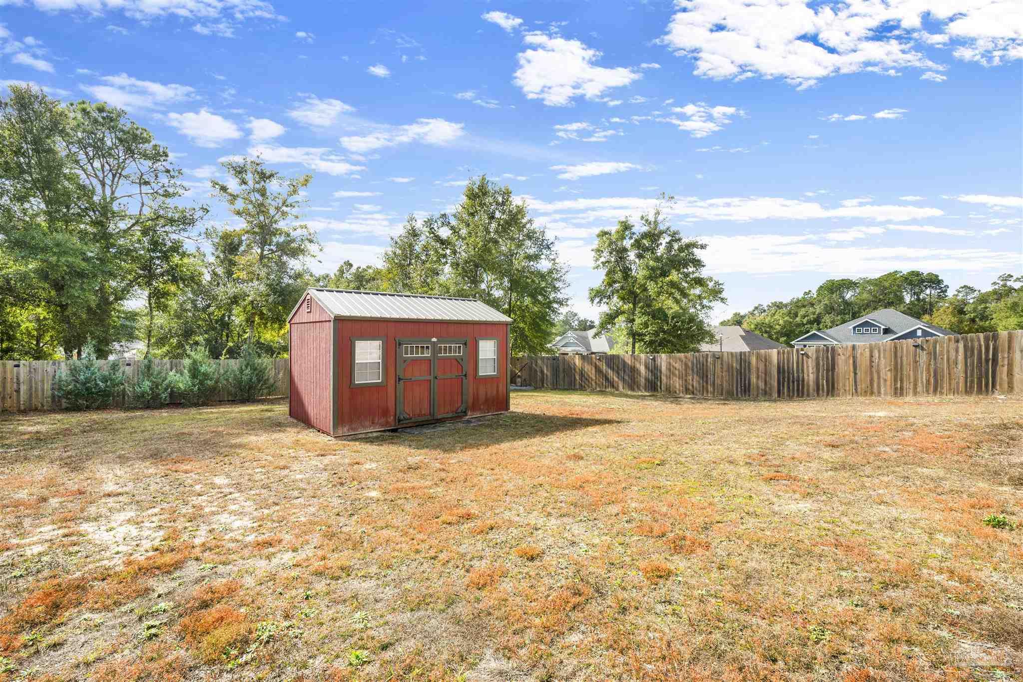 7907 Majestic Cypress Drive Milton, FL 32583 - Photo 33 of 36 a backyard of a house with lots of green space
