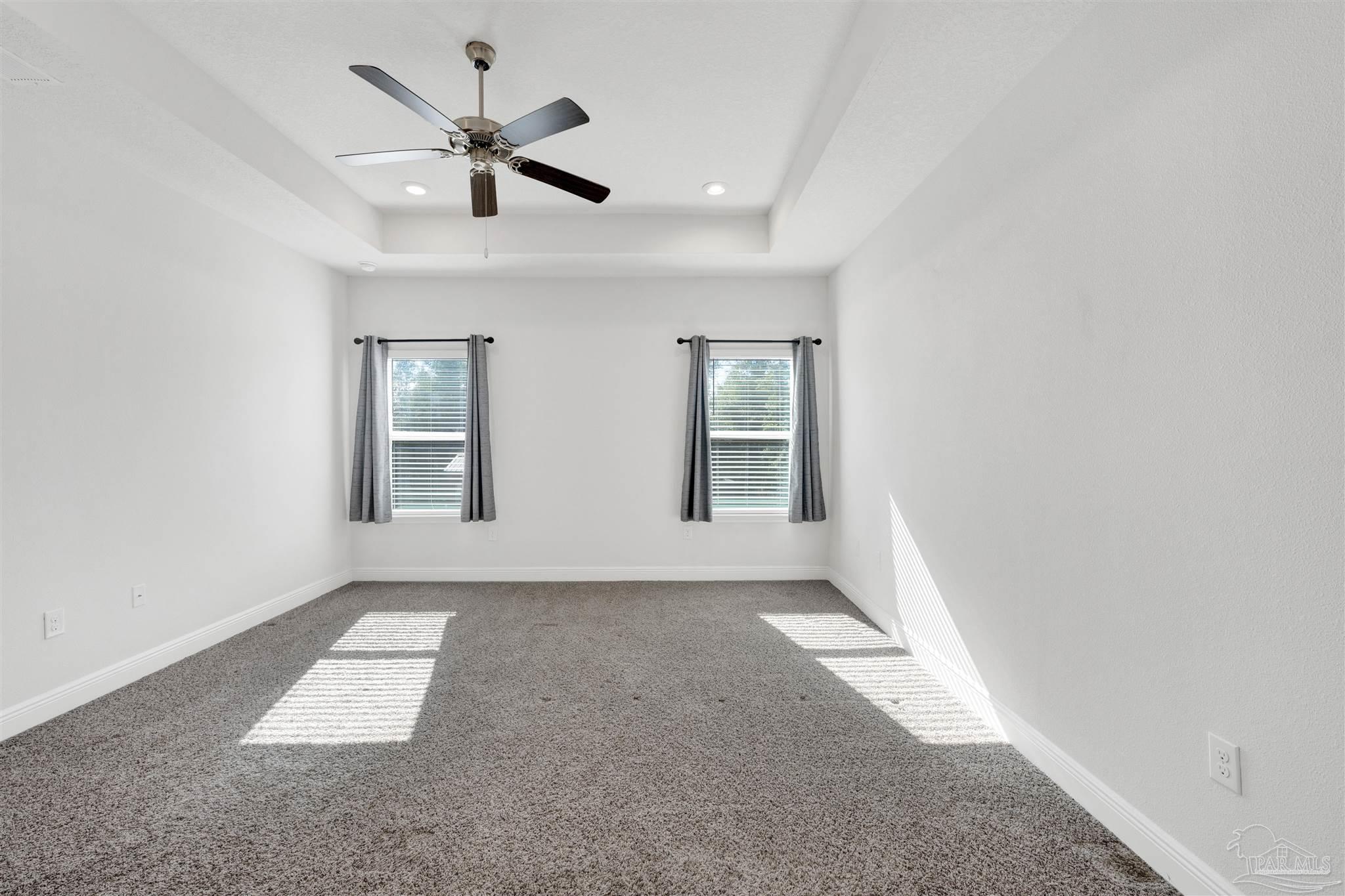 7907 Majestic Cypress Drive Milton, FL 32583 - Photo 6 of 36 an empty room with windows and ceiling fan