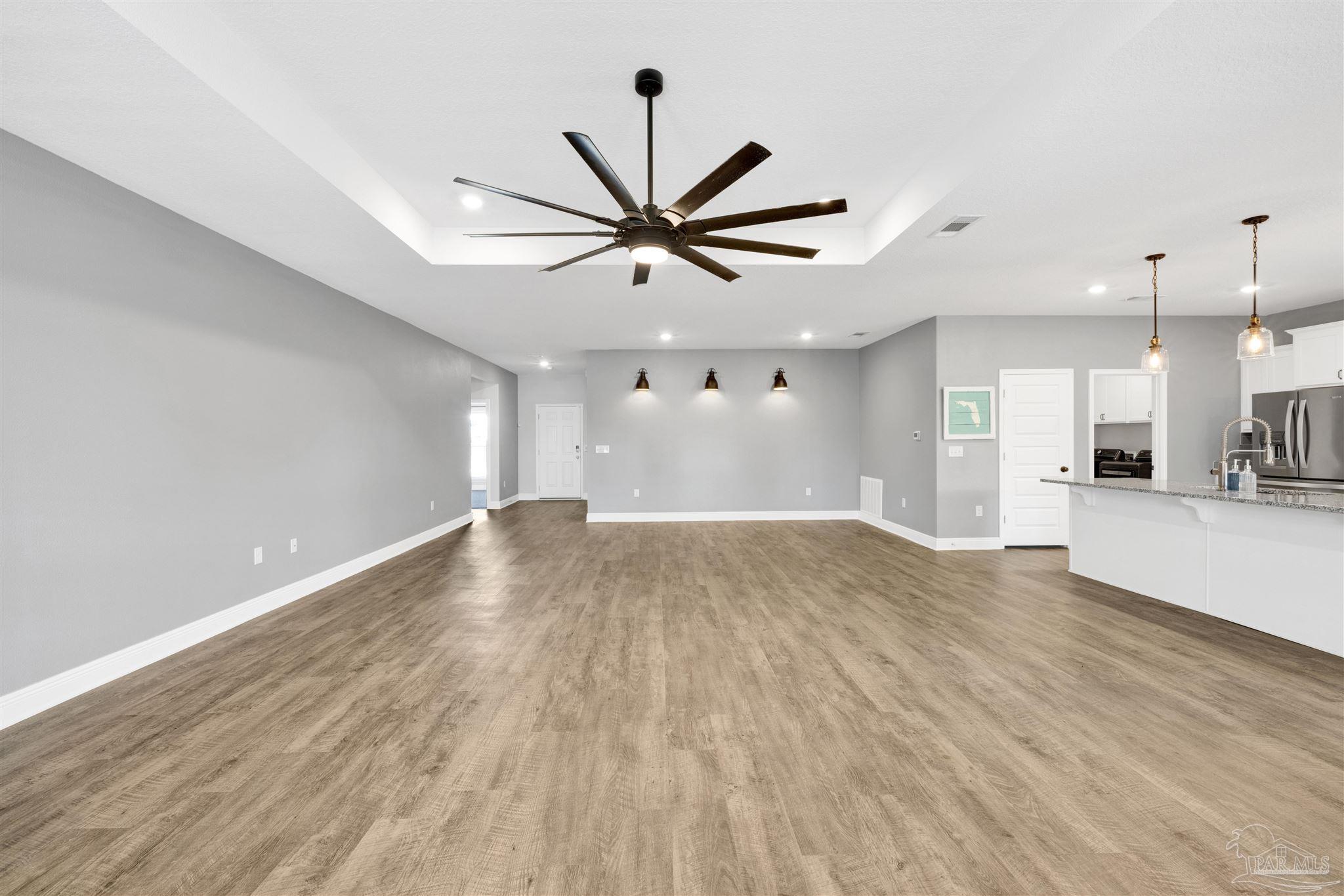 7907 Majestic Cypress Drive Milton, FL 32583 - Photo 9 of 36 a view of a livingroom with a ceiling fan window and a ceiling fan
