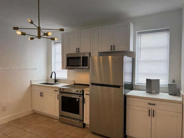 a kitchen with a refrigerator sink and microwave