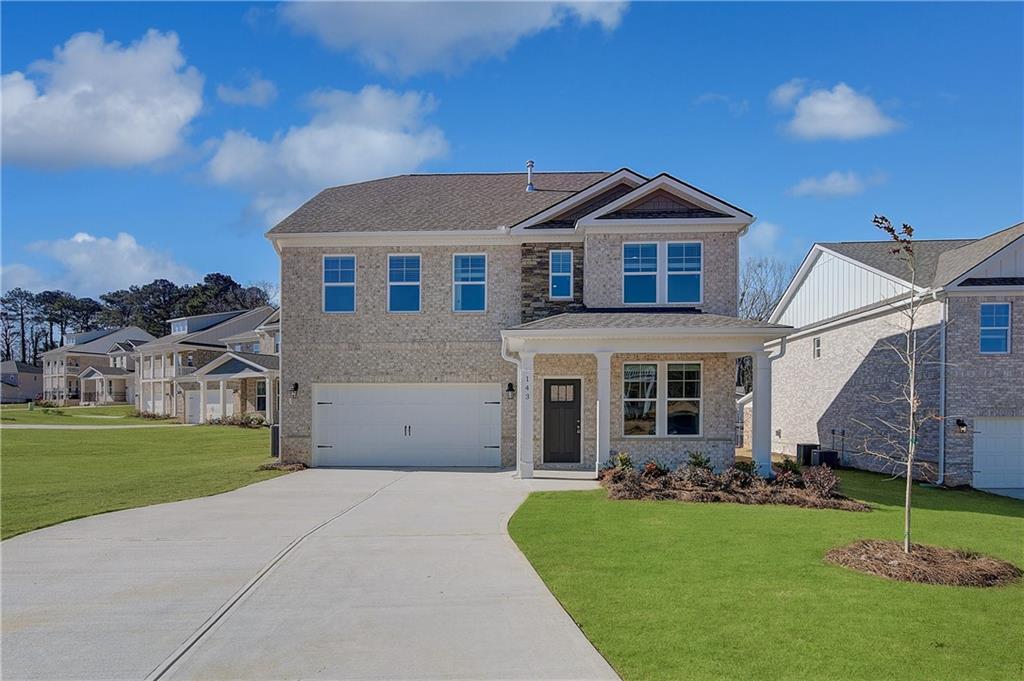 143 Dalston Cove Stockbridge, GA 30281 - Photo 2 of 32 a front view of a house with a yard and garage