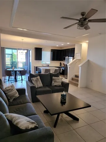 a living room with furniture a flat screen tv and a table