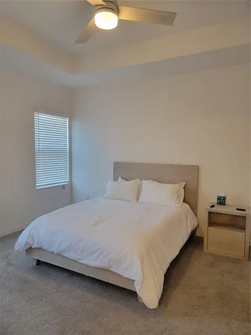 a bedroom with a bed and window