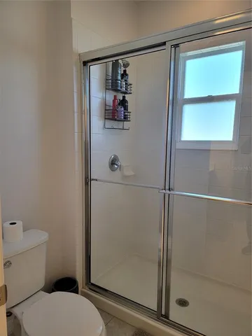 a bathroom with a toilet and a shower
