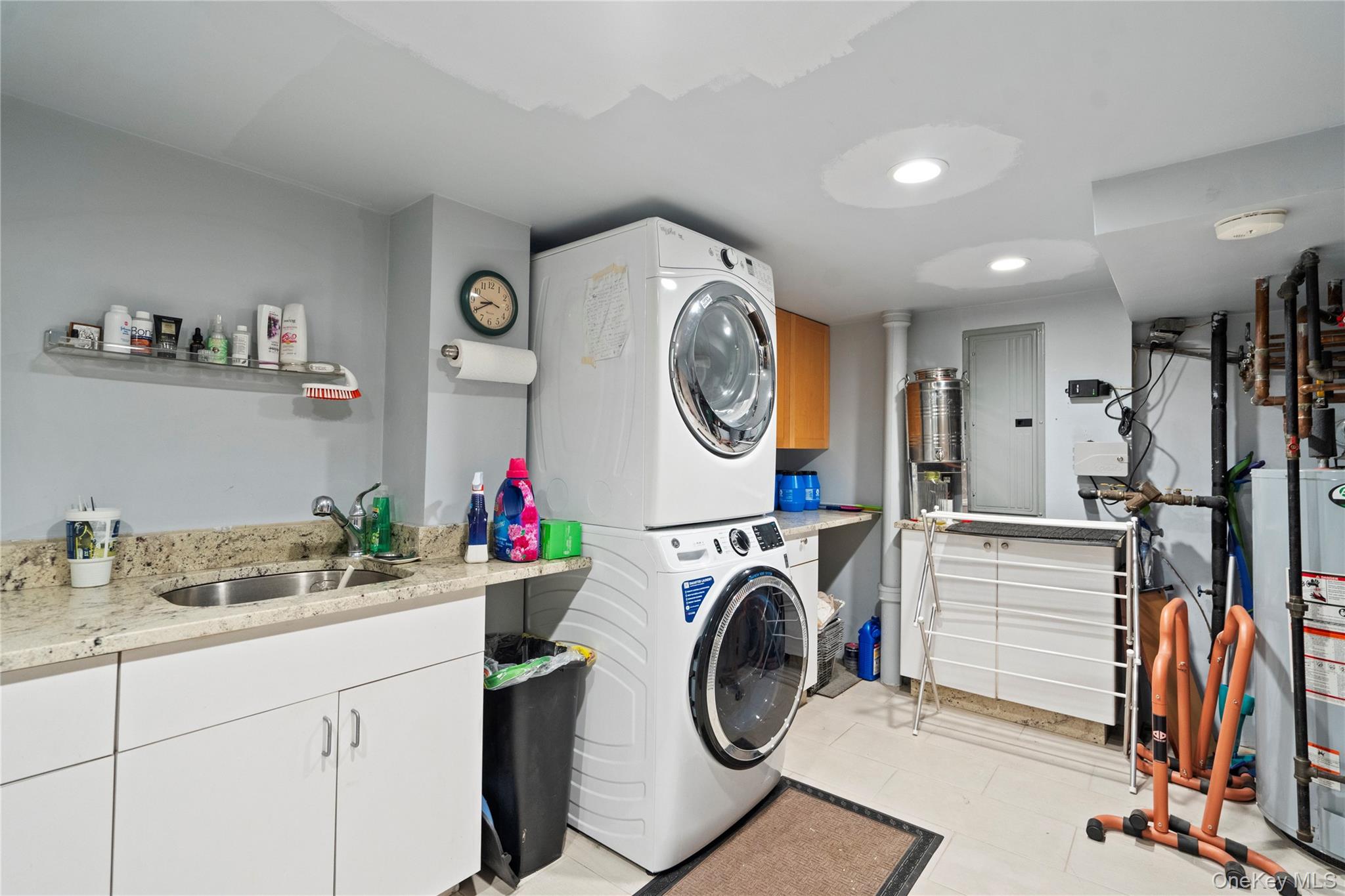 33 Shelter Hill Road Plainview, NY 11803 - Photo 22 of 34 Laundry area featuring stacked washing machine and dryer, recessed lighting, and cabinet space