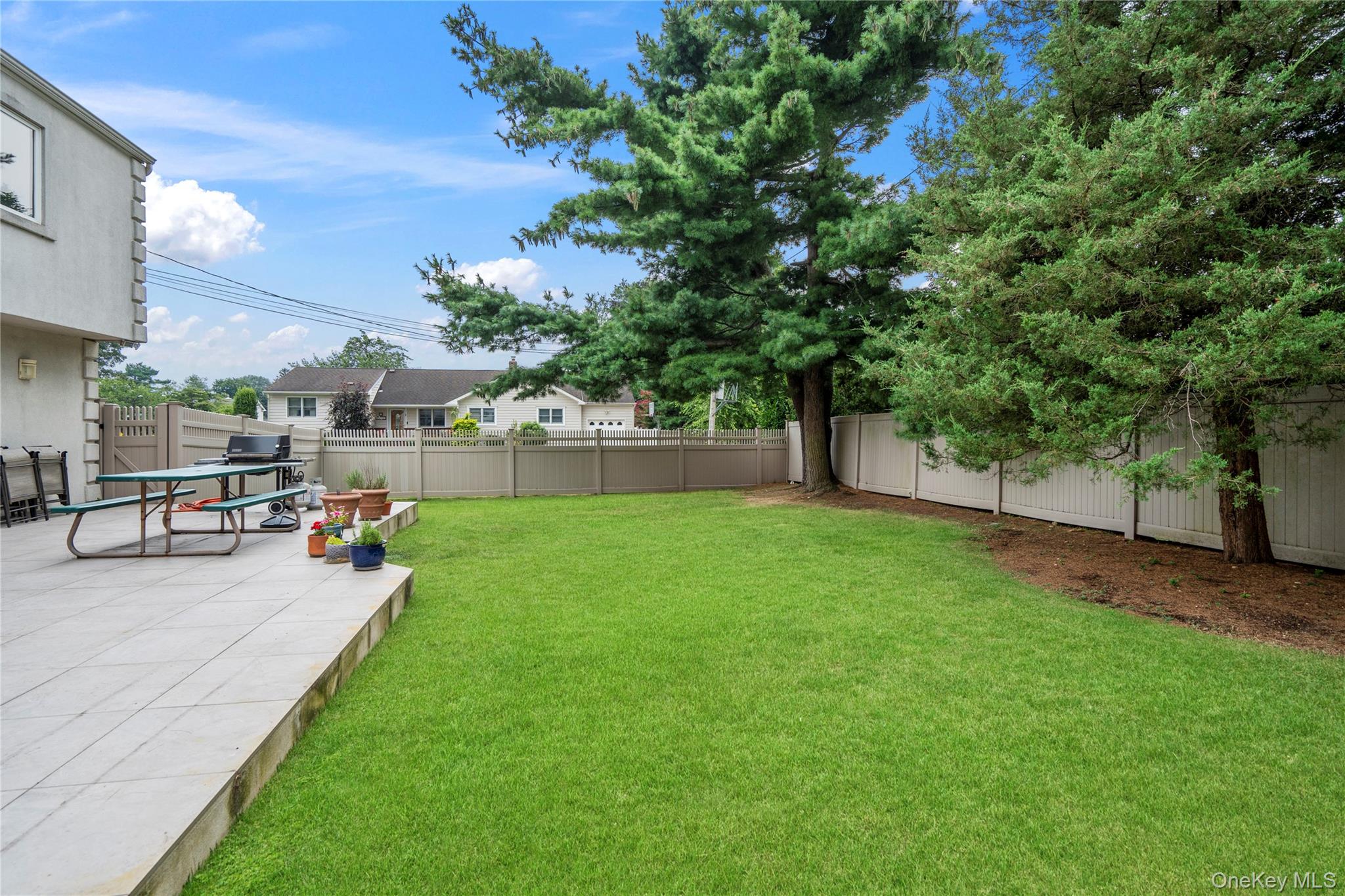 33 Shelter Hill Road Plainview, NY 11803 - Photo 28 of 34 Fenced backyard with a patio area