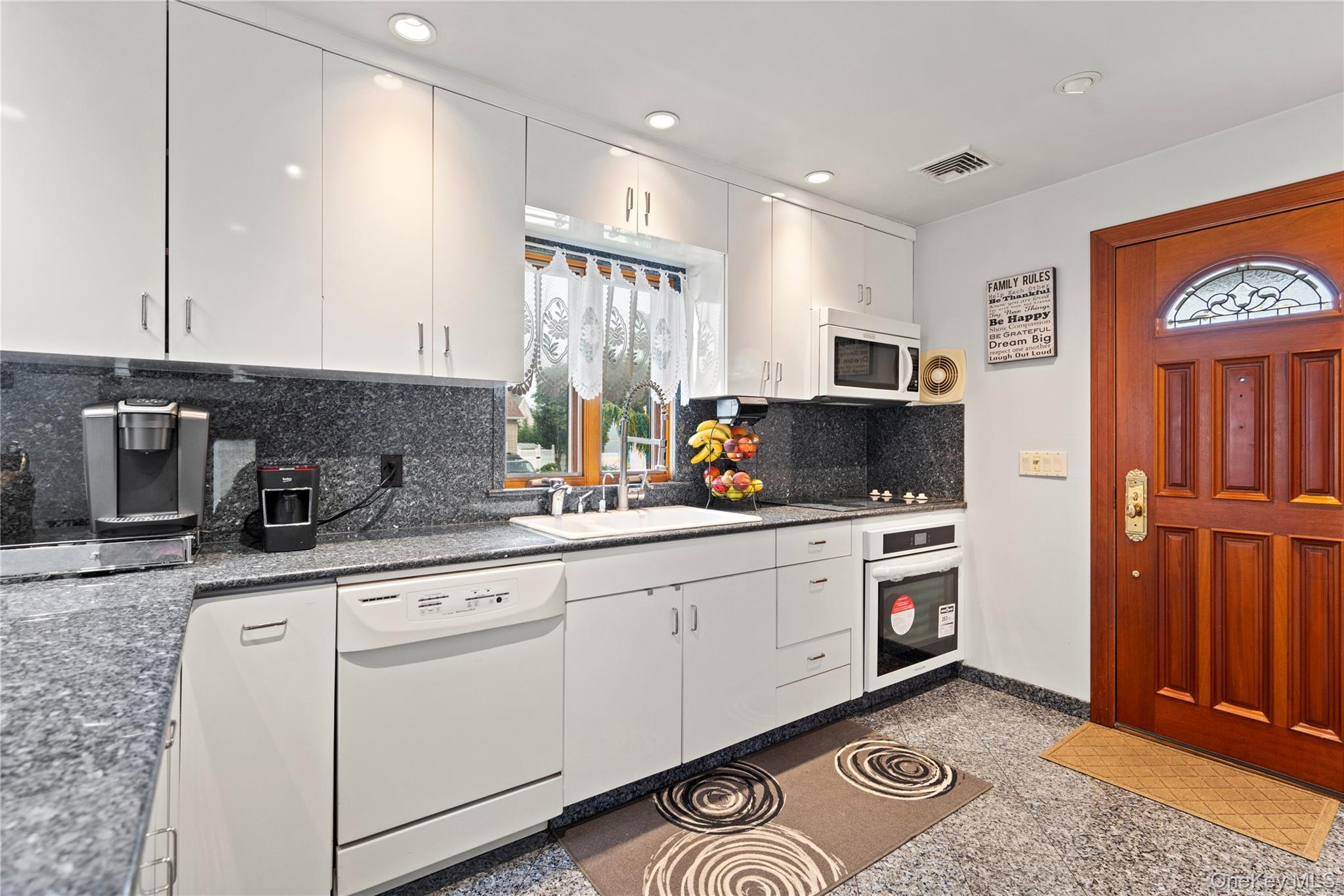 33 Shelter Hill Road Plainview, NY 11803 - Photo 7 of 34 White appliances, white cabinets, recessed lighting, granite counters and backsplash