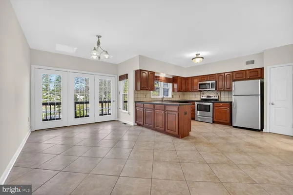 a view of front door deck and hardwood floor