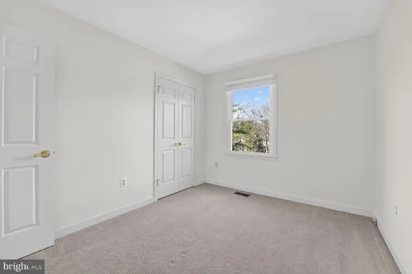 an empty room with fireplace and a window