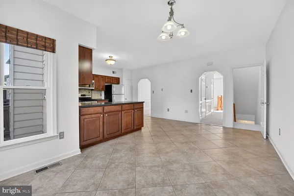 a kitchen with stainless steel appliances granite countertop a refrigerator sink and cabinets