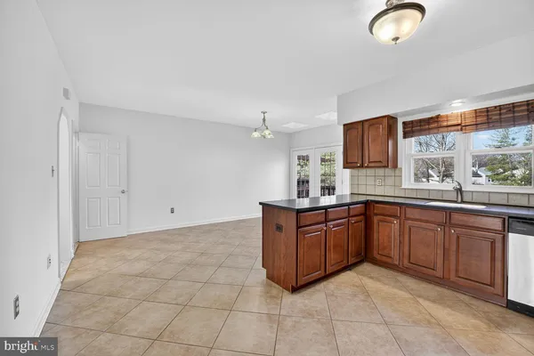 a open kitchen with cabinets and stainless steel appliances