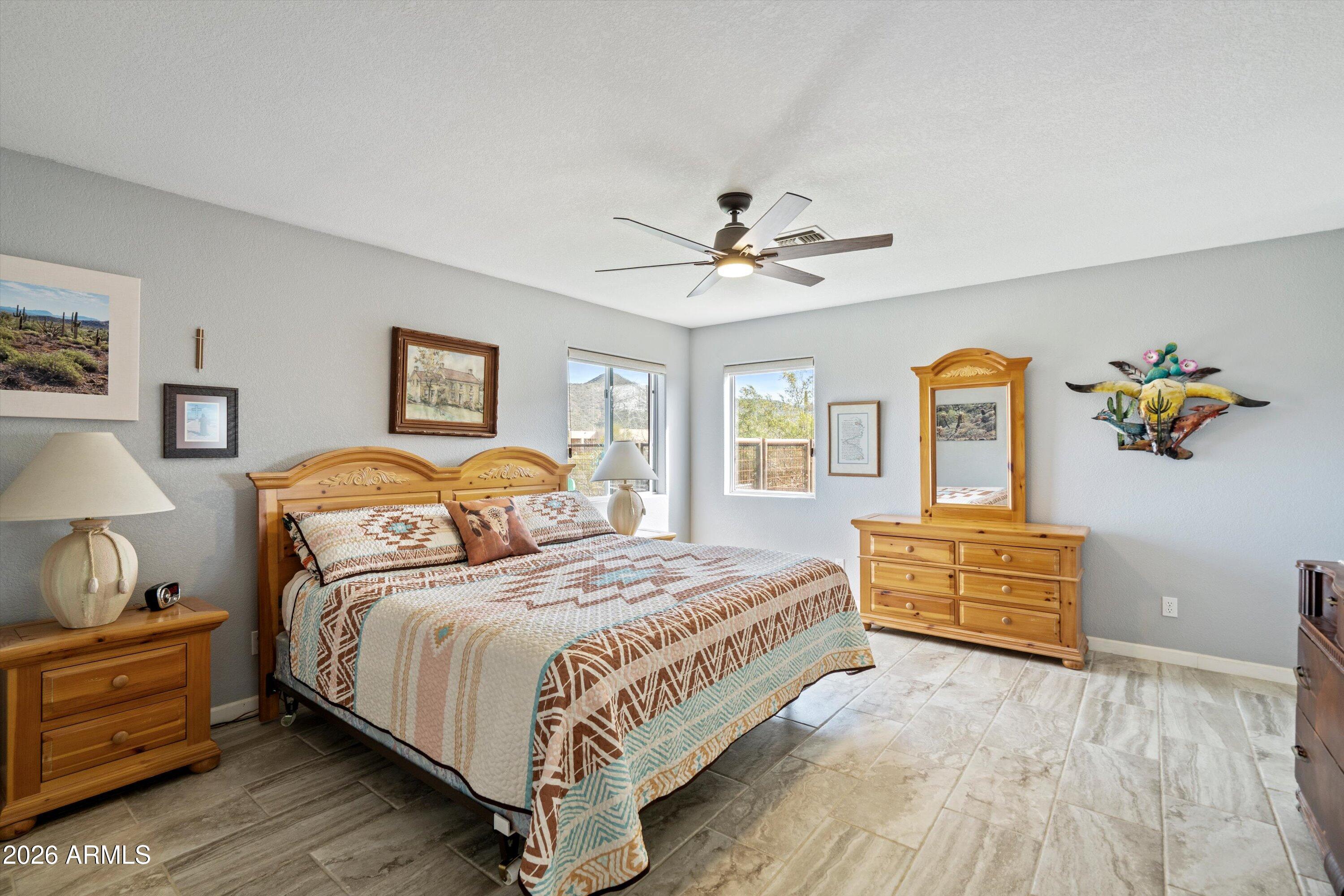 2316 West White Spar Road New River, AZ 85087 - Photo 14 of 40 a bedroom with a bed and wooden floor