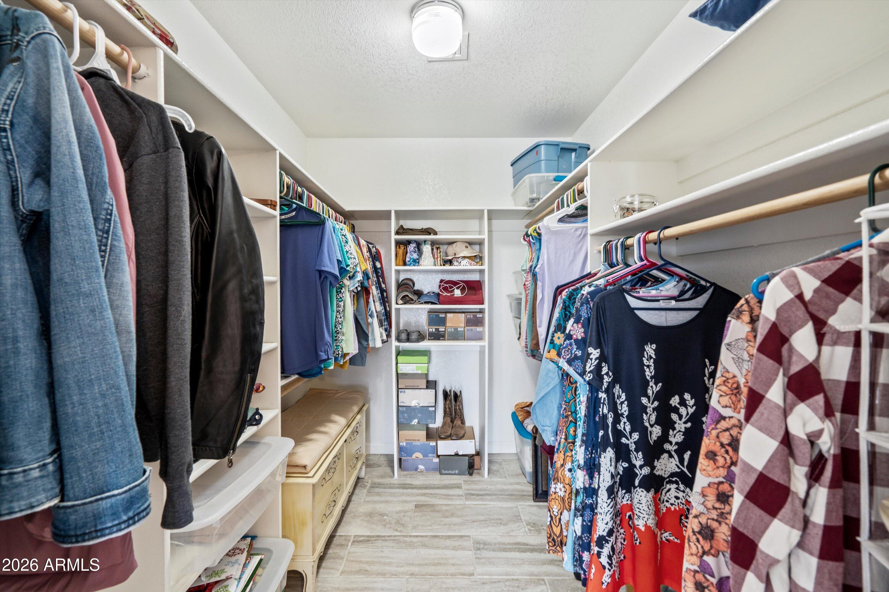 2316 West White Spar Road New River, AZ 85087 - Photo 18 of 40 a view of walk in closet with clothes and shoes