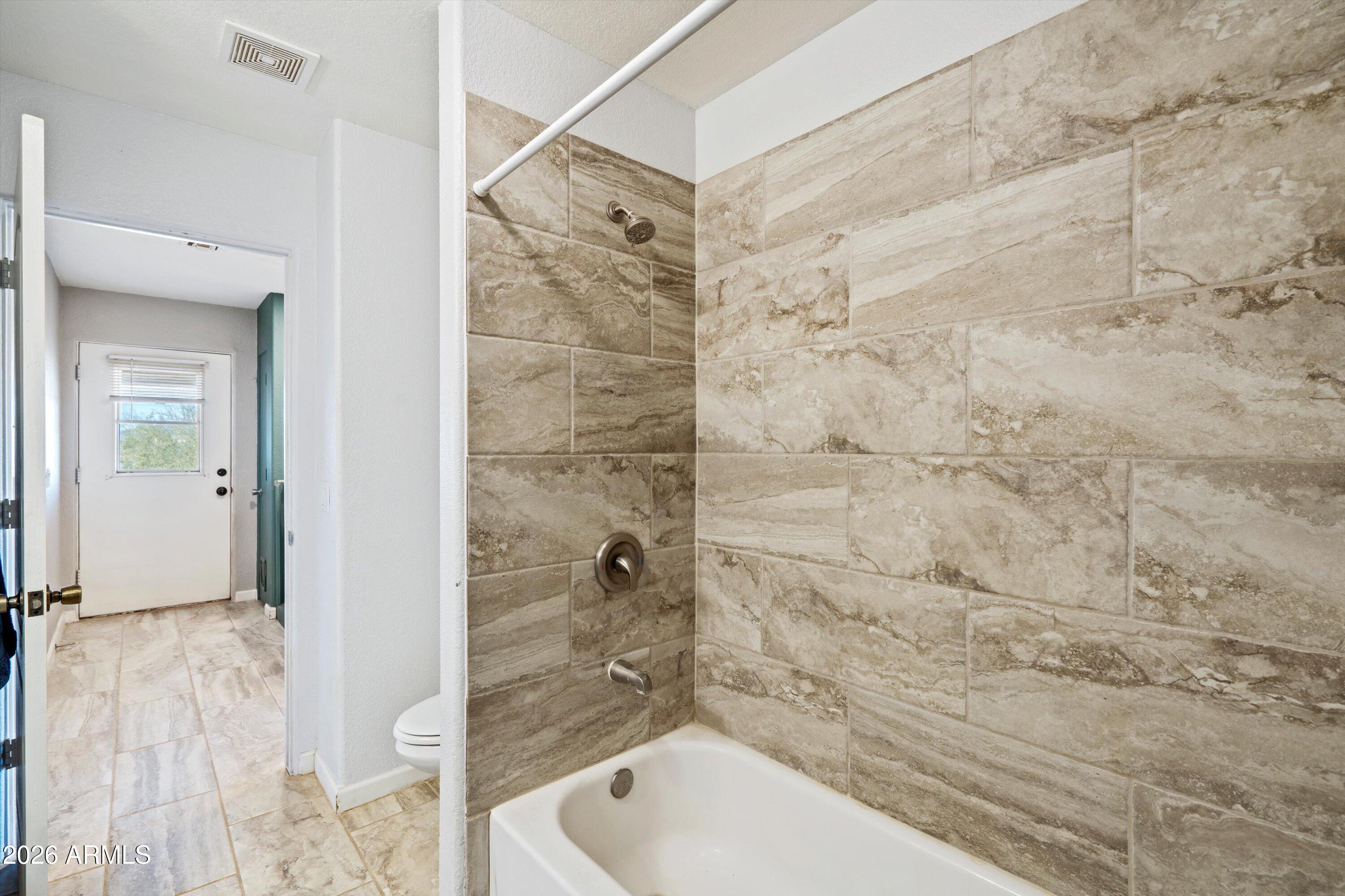 2316 West White Spar Road New River, AZ 85087 - Photo 21 of 40 a bathroom with a shower and a toilet