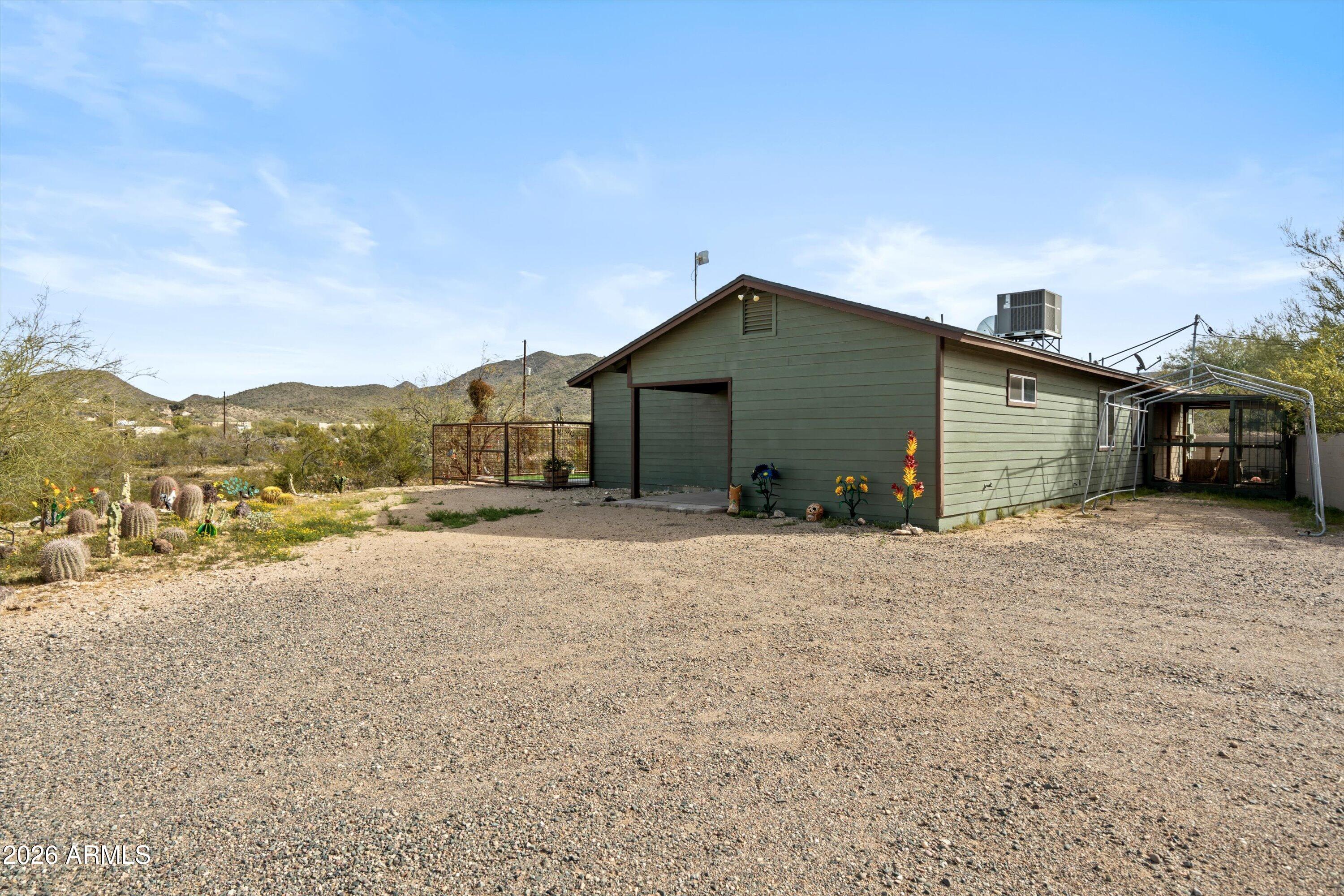 2316 West White Spar Road New River, AZ 85087 - Photo 26 of 40 a front view of a house with a yard and mountain view in back