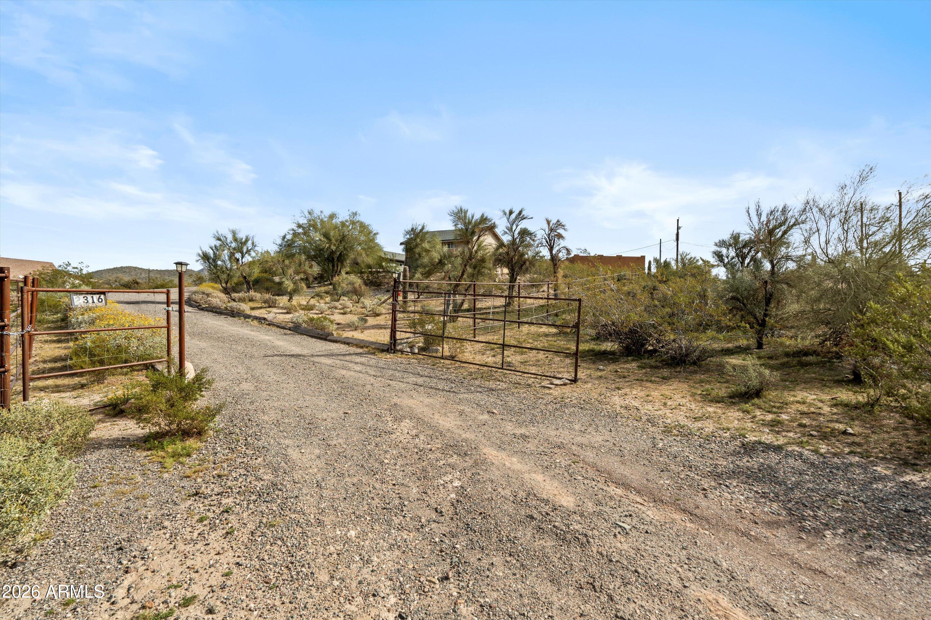 2316 West White Spar Road New River, AZ 85087 - Photo 33 of 40 a view of a dry yard with wooden fence