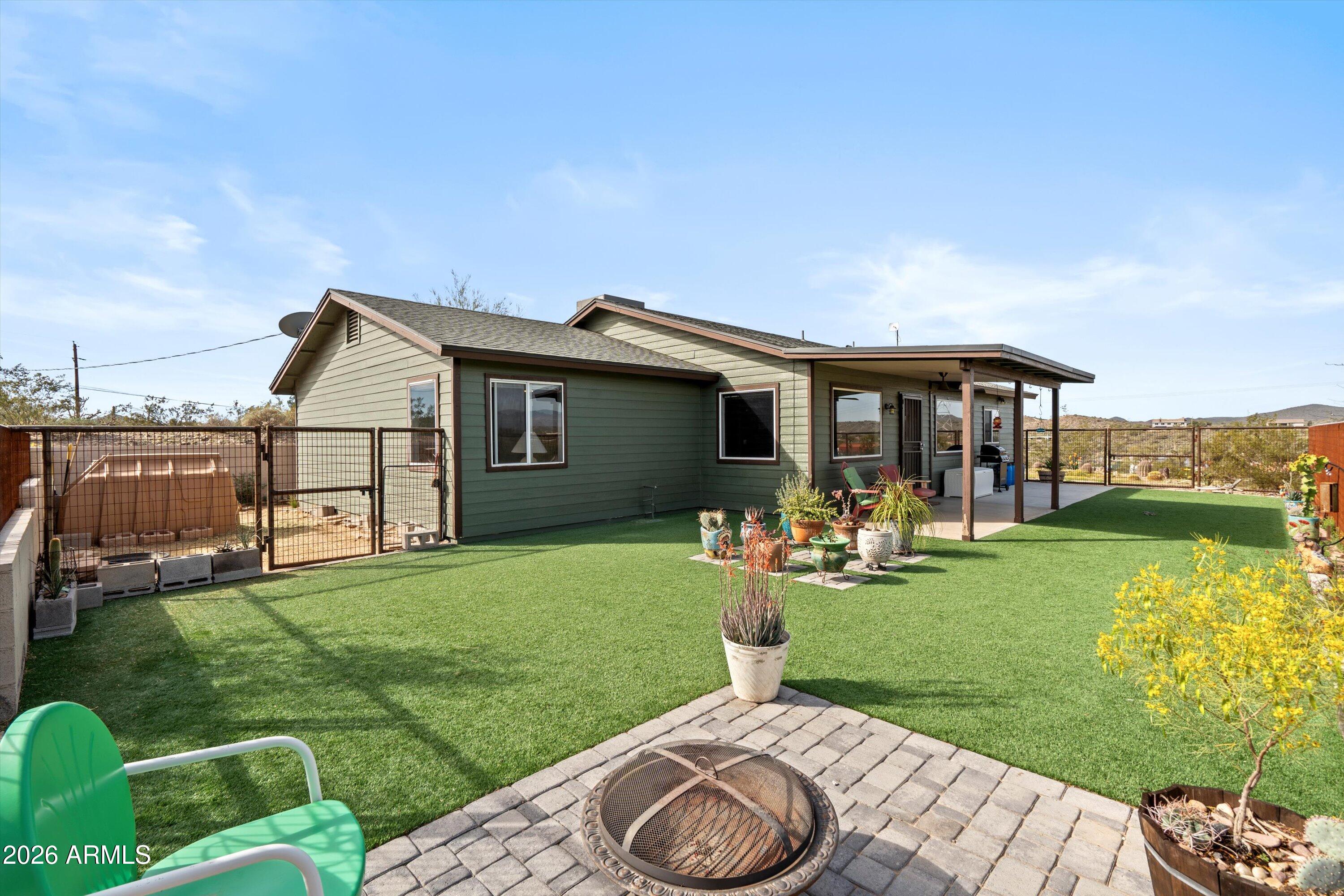 2316 West White Spar Road New River, AZ 85087 - Photo 3 of 40 a view of a house with backyard sitting area and garden
