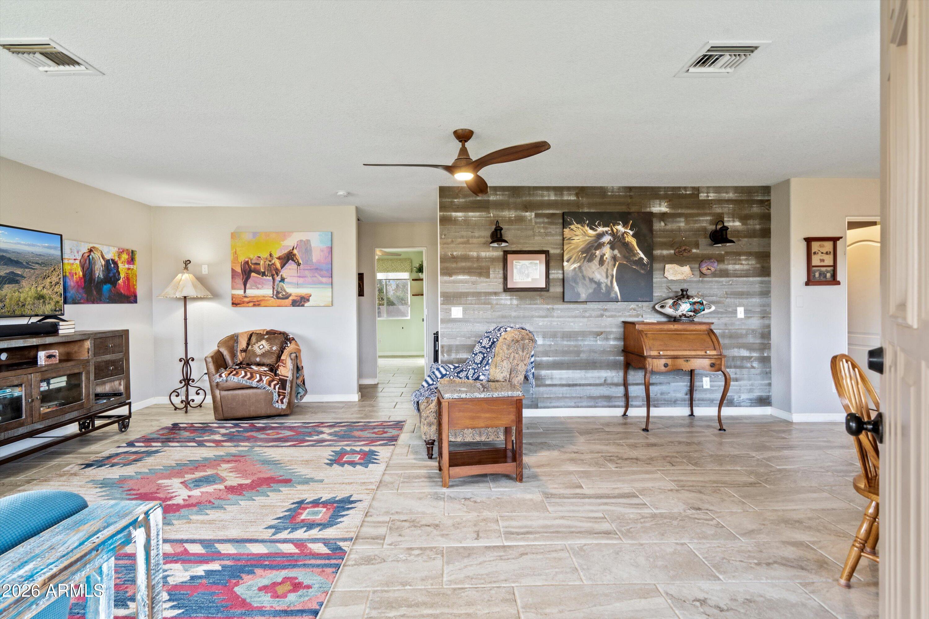 2316 West White Spar Road New River, AZ 85087 - Photo 5 of 40 a bedroom with furniture and a wooden floor
