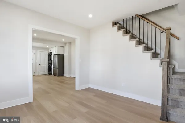 a view of hallway with wooden floor