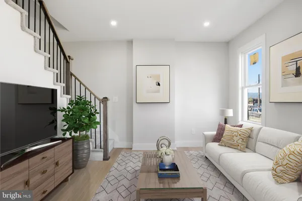 a living room with furniture bookshelf and a flat screen tv