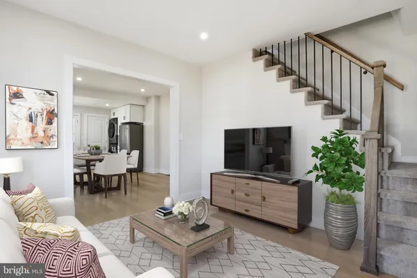 a living room with furniture potted plant and a flat screen tv