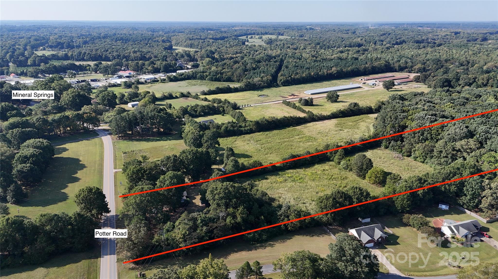 3004 Potter Road Waxhaw, NC 28173 - Photo 2 of 15 an aerial view of a house with a garden and lake view
