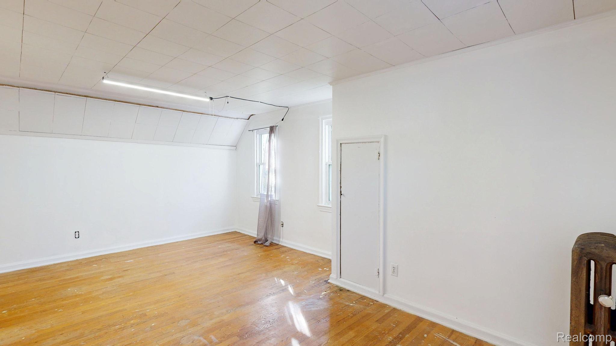 4455 North Genesee Road Flint, MI 48506 - Photo 19 of 47 Empty room with light wood-style floors and baseboards