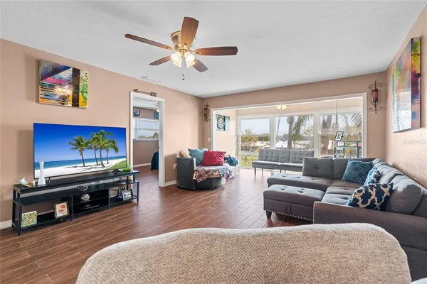 a living room with furniture and a flat screen tv with wooden floor