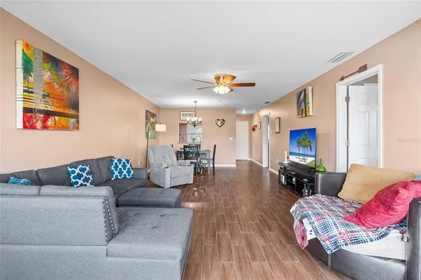 a living room with furniture and wooden floor