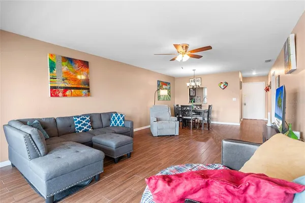 a living room with furniture and wooden floor