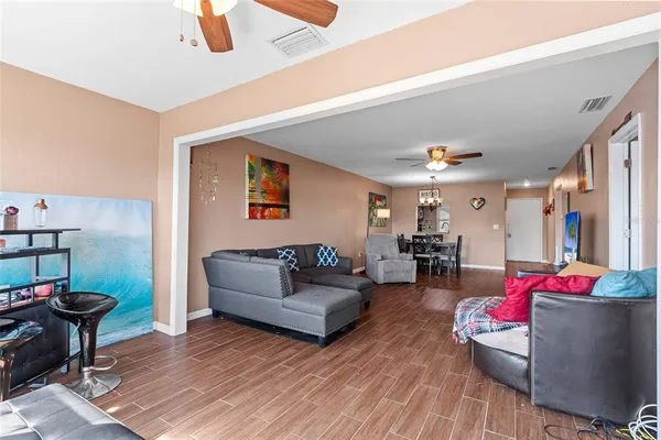 a living room with furniture and a wooden floor
