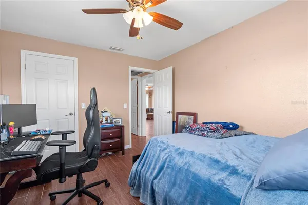 a bedroom with a bed and a chandelier