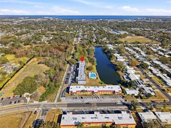 an aerial view of residential building and lake