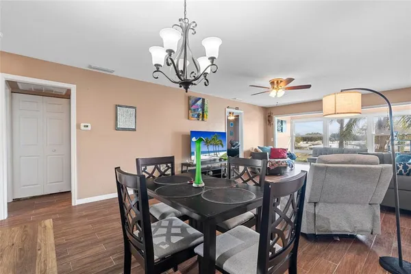 a view of a dining room with furniture wooden floor and chandelier