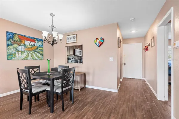 a view of a dining room with furniture wooden floor and chandelier