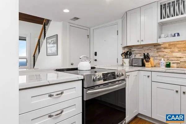 a kitchen with stainless steel appliances granite countertop a refrigerator sink and stove