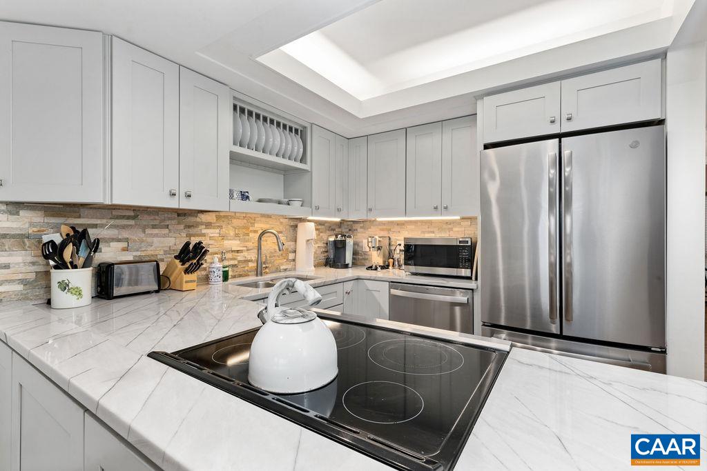 1478 Ledges Condos Roseland, VA 22967 - Photo 17 of 50 a kitchen with stainless steel appliances granite countertop a sink stove and refrigerator