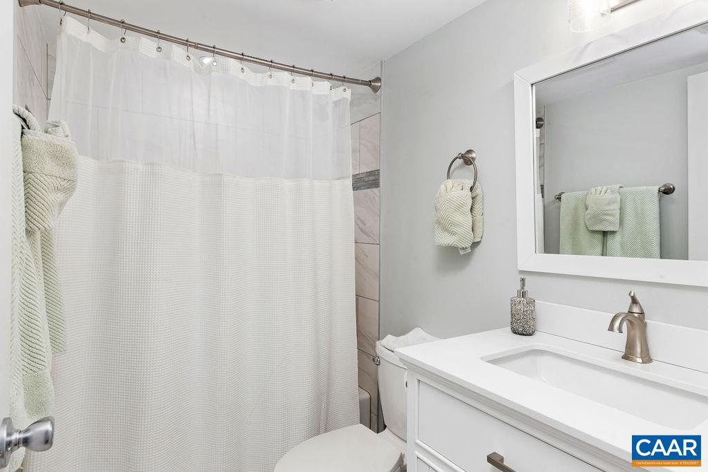 1478 Ledges Condos Roseland, VA 22967 - Photo 28 of 50 a bathroom with a granite countertop sink and a mirror