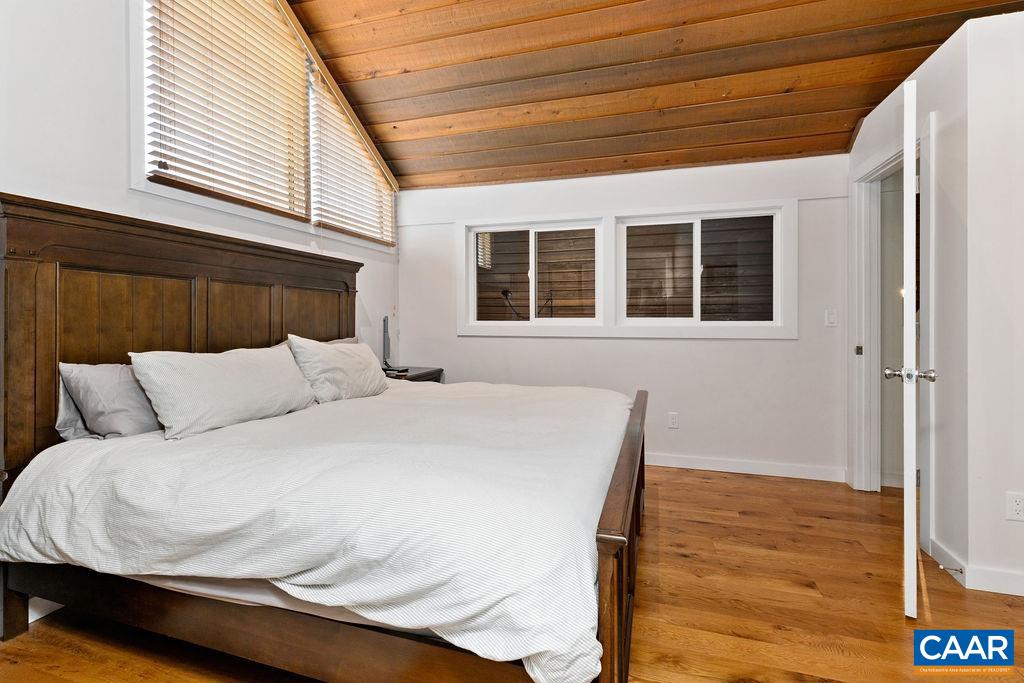 1478 Ledges Condos Roseland, VA 22967 - Photo 34 of 50 a large bed sitting in a bedroom next to a window