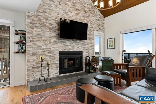 a living room with furniture a flat screen tv and a fireplace